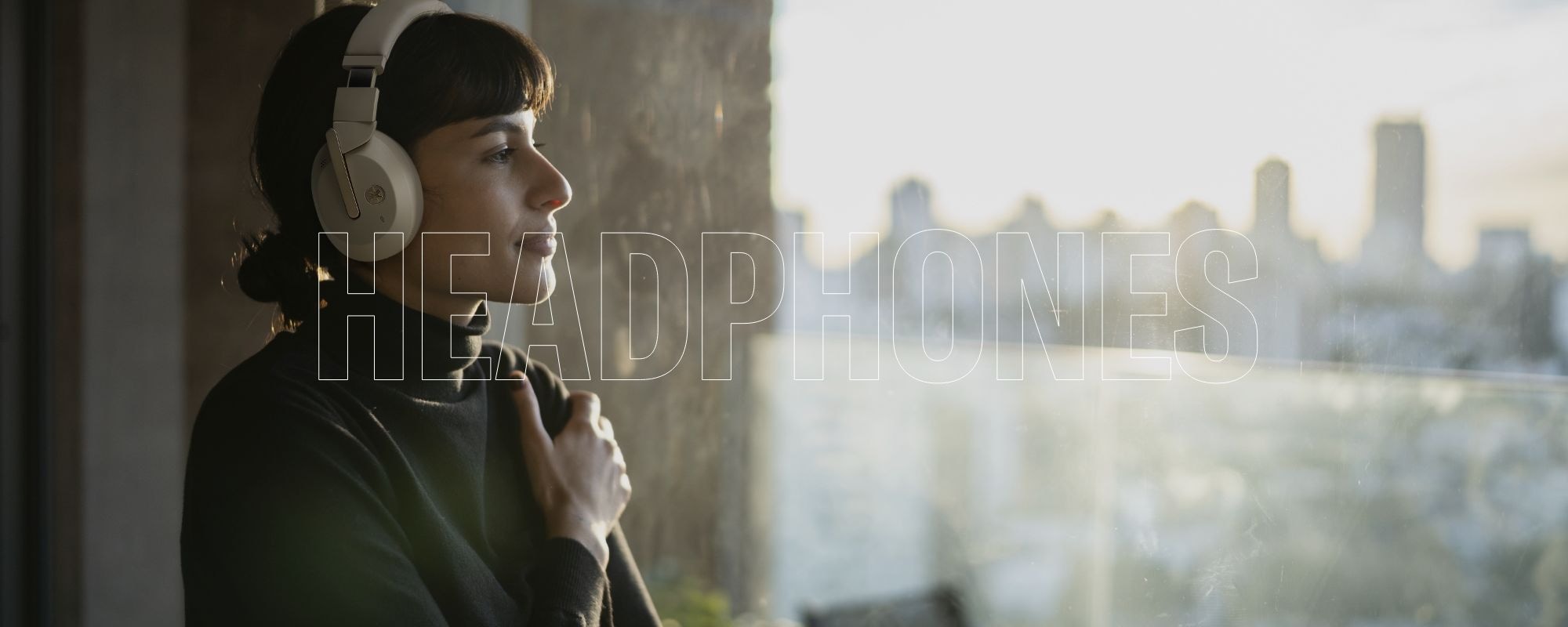 Lifestyle image showing a woman wearing Yamaha YH-E700B beige color headphone