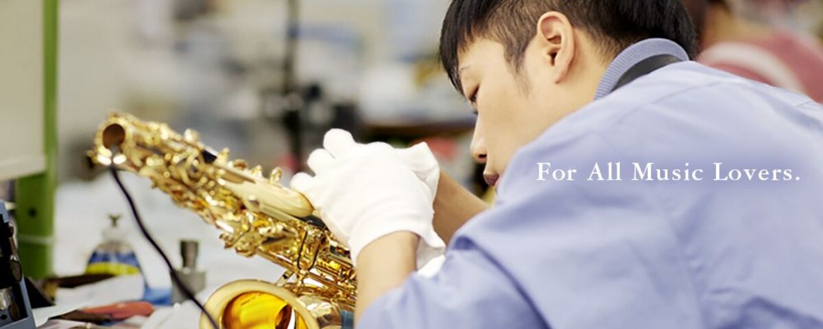 A yamaha technician inspecting a yamaha saxophone with the text for all music lovers