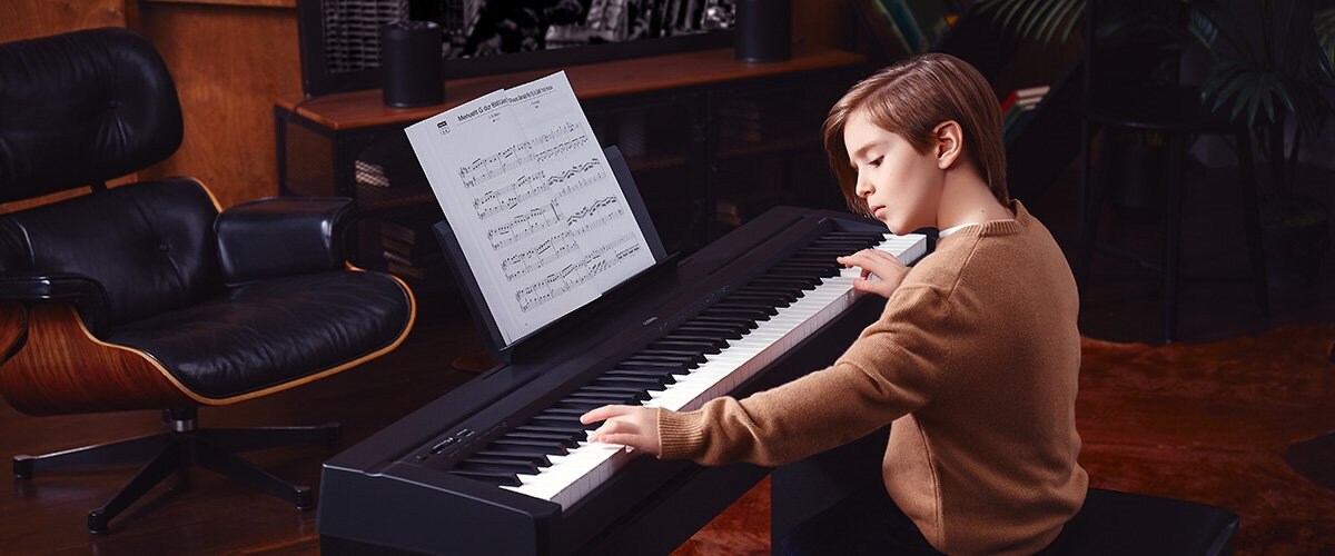 Kid playing P-45 Piano